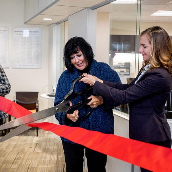 Cutting a celebratory ribbon are, from left, Dr. Kristen Woods, president of Trinity Health Medical Group; GVSU President Philomena V. Mantella; and Kate Harmon, GVSU acting assistant vice president for Student Affairs.