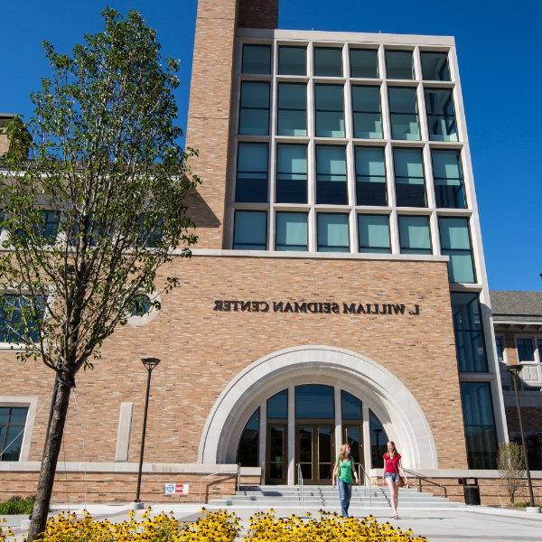 Two students exit the L. William Seidman Center on the Pew Grand Rapids Campus