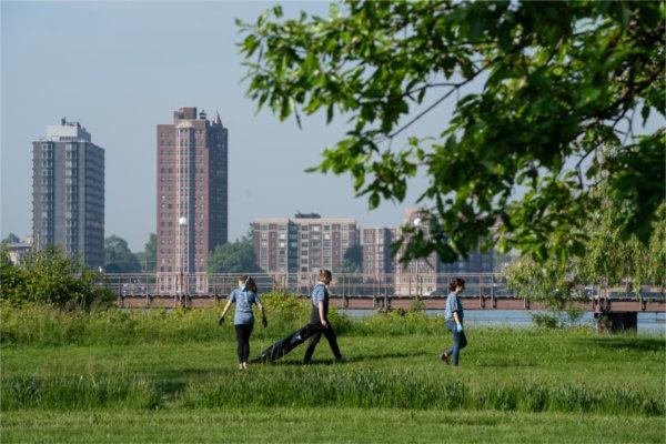 Volunteers with Michigan Cares for 旅游 collect trash on Belle Isle Park.